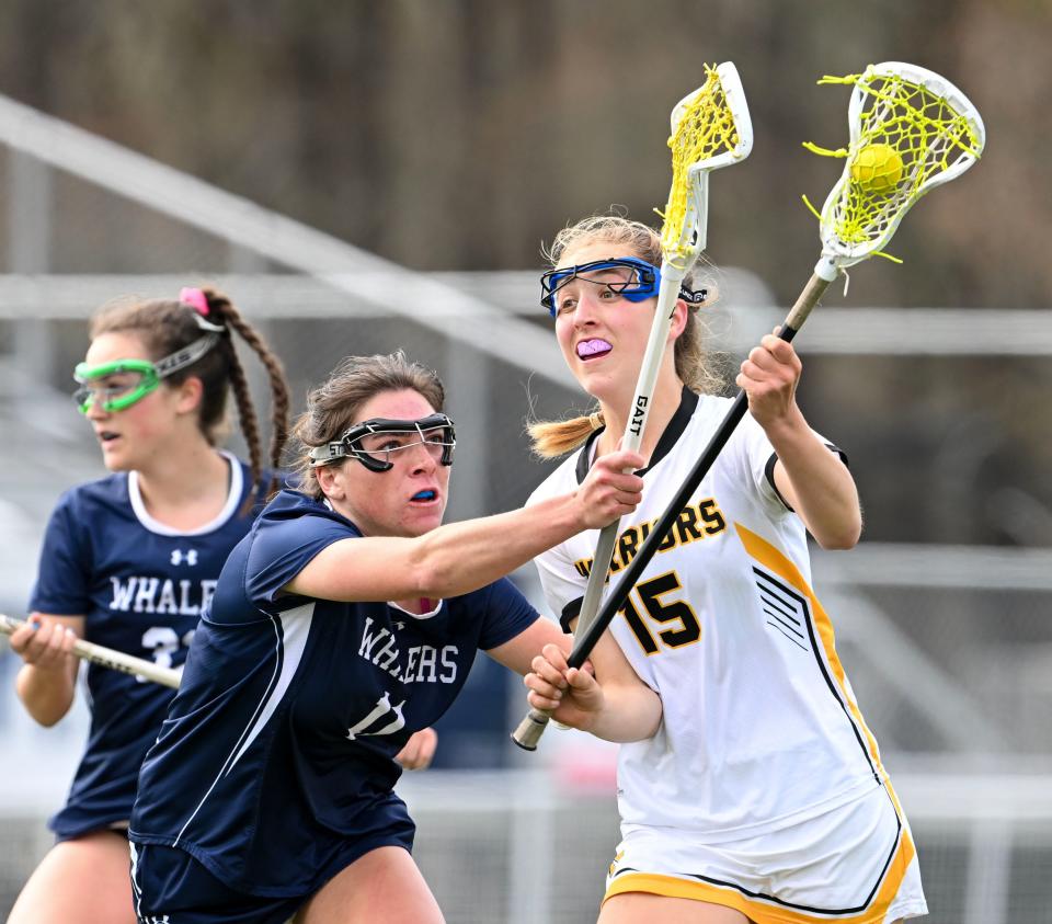 Emerson Pekarcik of Nantucket attempts to stop a shot by Julia Kipperman of Nauset.