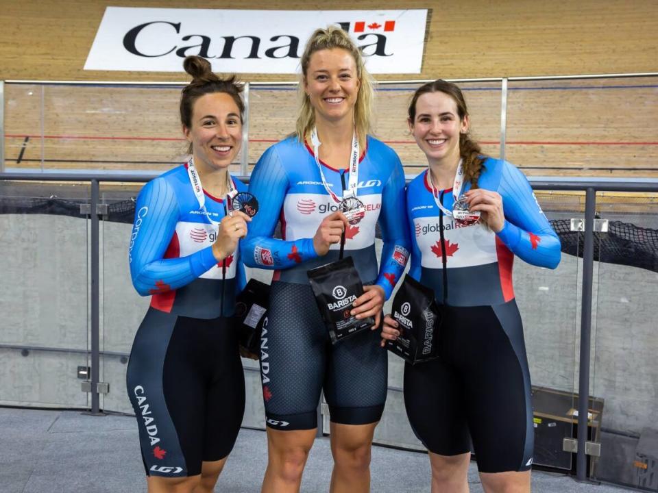 Canada's Lauriane Genest, Kelsey Mitchell and Sarah Orban pose with their team sprint silver medals at the UCI Track Nations Cup on Friday at the Mattamy National Cycling Centre in Milton, Ont. (Ivan Rupes/Cycling Canada - image credit)