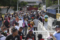 Pedestrians use the Simon Bolivar International Bridge to cross between San Antonio, Venezuela, behind, and Cucuta, Colombia, Friday, Aug. 5, 2022, on the border that is open to pedestrian traffic but closed to cargo trucks. The border will gradually reopen after the two nations restore diplomatic ties when Colombia's new president is sworn-in on Aug. 7, according to announcement in late July by Colombia's incoming Foreign Minister Alvaro Leyva and Venezuelan Foreign Minister Carlos Faria. (AP Photo/Matias Delacroix)