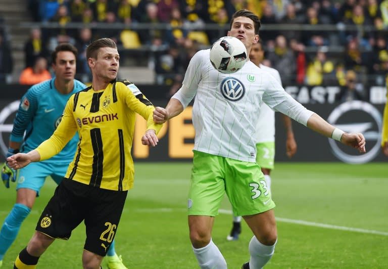 Dortmund's Lukasz Piszczek and Wolfsburg's Mario Gomez vie for the ball in Dortmund on February 18, 2017