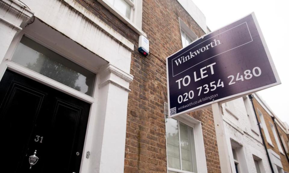 A white and purple Winkworth 'to let' sign on the side of a building