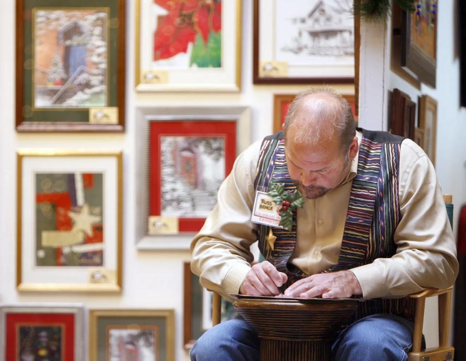 An artist and vendor is shown at the Christkindl Markt in 2009. The juried fine arts and crafts show is marking its 50th anniversary at this weekend's event.