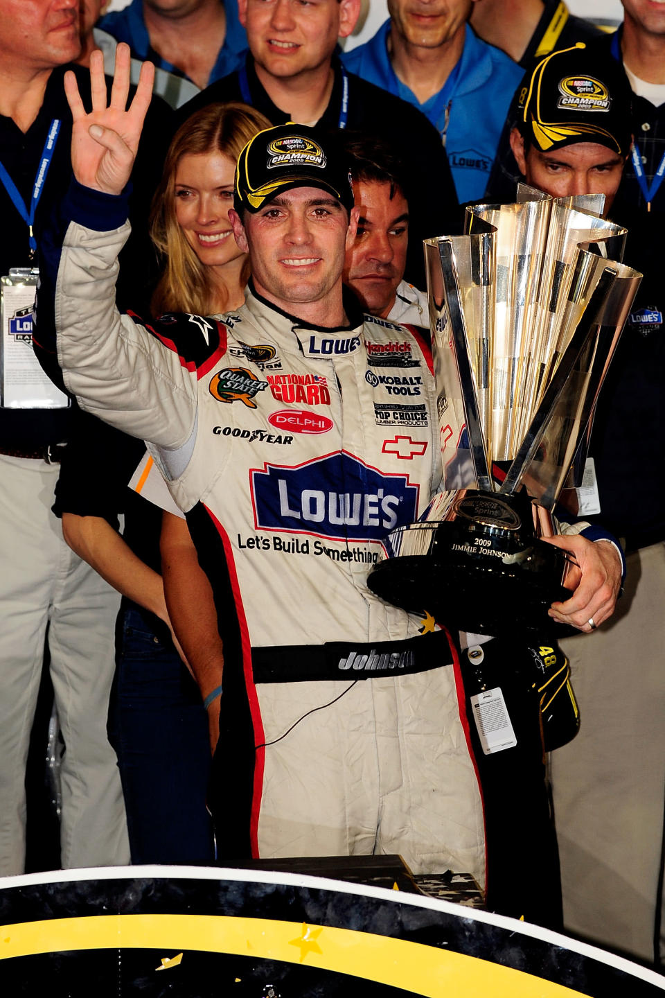 Jimmie Johnson, driver of the #48 Lowe's Chevrolet, celebrates after winning the NASCAR Sprint Cup Series Championship after finishing in fifth place in the Ford 400 at Homestead-Miami Speedway on November 22, 2009 in Homestead, Florida. Johnson becomes the first driver in the history of NASCAR to win four consecutive championships since the sports inception in 1949.during the NASCAR Sprint Cup Series Ford 400 at Homestead-Miami Speedway on November 22, 2009 in Homestead, Florida. (Photo by Sam Greenwood/Getty Images)