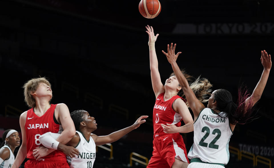 Japan's Moeko Nagaoka (0), second right, shoots over Nigeria's Oderah Chidom (22), right, during women's basketball preliminary round game at the 2020 Summer Olympics, Monday, Aug. 2, 2021, in Saitama, Japan. (AP Photo/Charlie Neibergall)