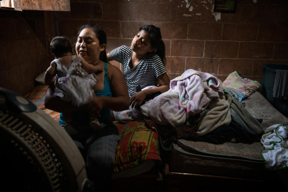 Heidi Hernandez, 29, and her sister Julisa, with Heidi's 2-month-old baby at home, in Tres Reyes, a shanty-town located on the outskirts of Cancún, on Oct. 16. Heidi's baby was due in the middle of the pandemic, but no midwife wanted to help her deliver at home, so Heidi ended up giving birth in the hospital, despite her fear of the virus.<span class="copyright">Claudia Guadarrama—Magnum Foundation for TIME</span>