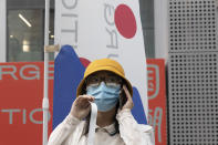 A woman wears a mask to prevent the spread of the coronavirus as she visits a weekend open air market in Beijing on Saturday, Aug. 8, 2020. As the coronavirus outbreak comes under control in the Chinese capital, normal life is slowing returning albeit with the requisite masks. (AP Photo/Ng Han Guan)