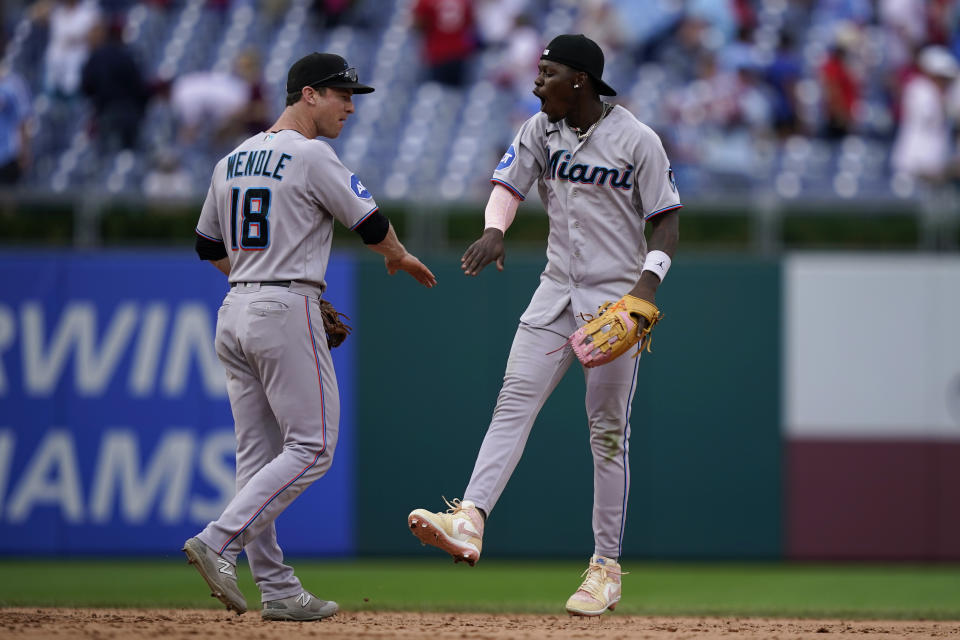 Miami Marlins' Joey Wendle, left, and Jazz Chisholm Jr. celebrate after the Marlins won a baseball game against the Philadelphia Phillies, Sunday, Sept. 10, 2023, in Philadelphia. (AP Photo/Matt Slocum)