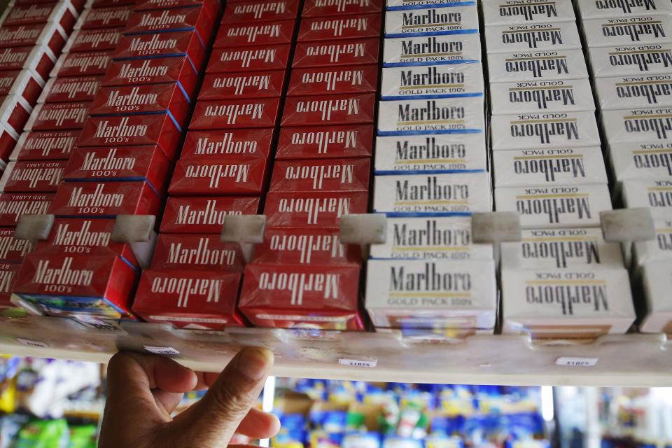 Packs of Marlboro cigarettes are displayed for sale at a convenience store in Somerville, Massachusetts July 17, 2014. Cigarette maker Philip Morris International Inc cut its earnings forecast for 2014 and said it is proving to be a "complex and truly atypical" year for the company. REUTERS/Brian Snyder (UNITED STATES - Tags: HEALTH BUSINESS)