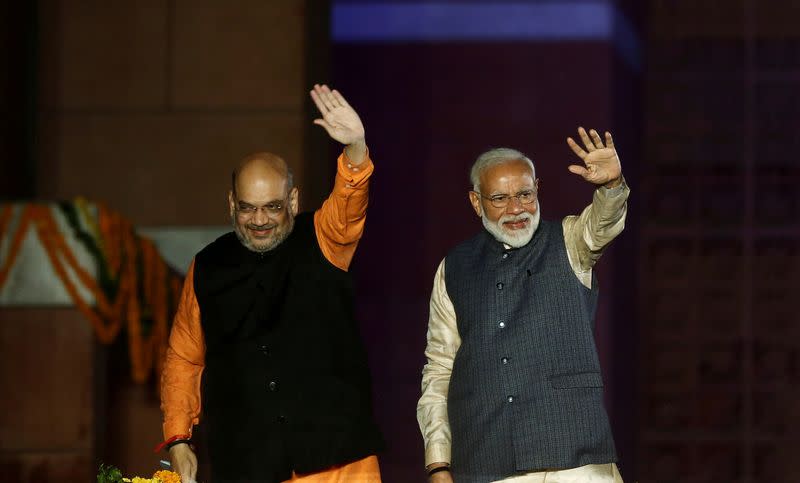 FILE PHOTO: Indian Prime Minister Narendra Modi and Bharatiya Janata Party (BJP) President Amit Shah wave towards their supporters after the election results at party headquarter in New Delhi