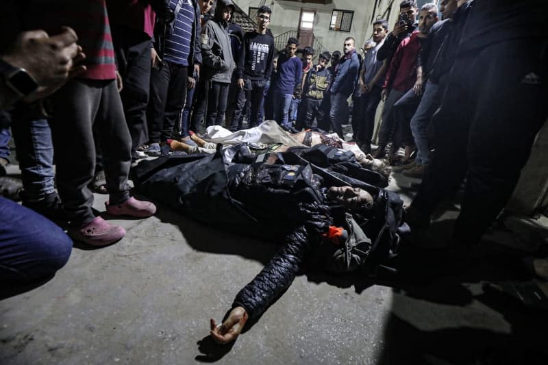 Bodies of the deceased officials of the US-based international volunteer aid organization World Central Kitchen (WCK), can be seen on the ground following an Israeli attack on a WCK vehicle in Deir Al-Balah. Omar Ashtawy/APA Images via ZUMA Press Wire/dpa