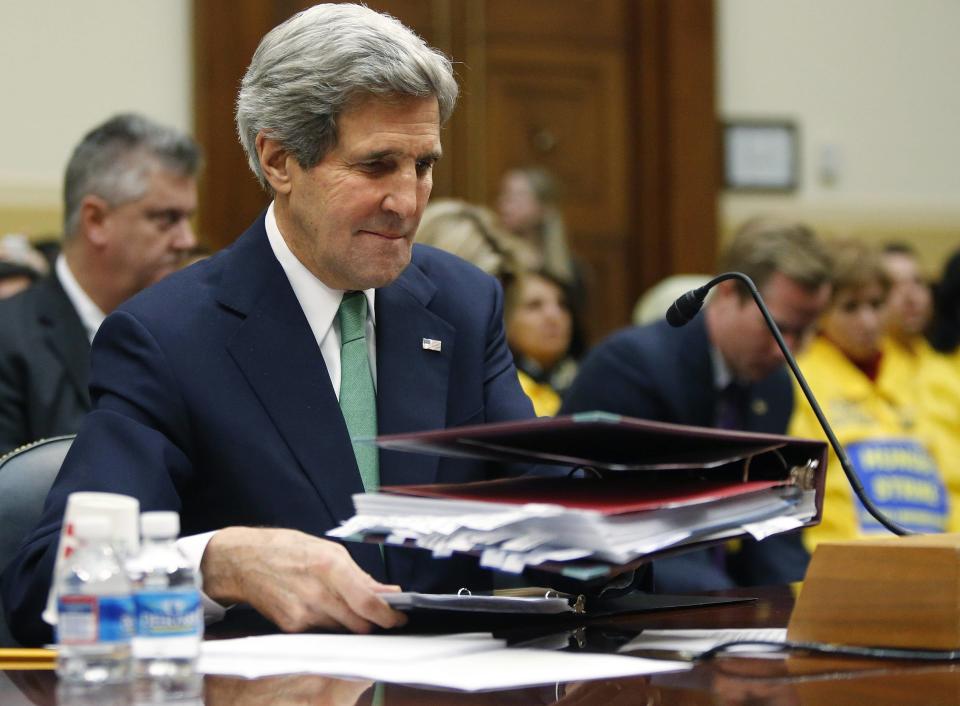 Kerry places his notes on the table before testifying on agreements over Iran's nuclear programs, before the House Foreign Affairs Committee on Capitol Hill in Washington