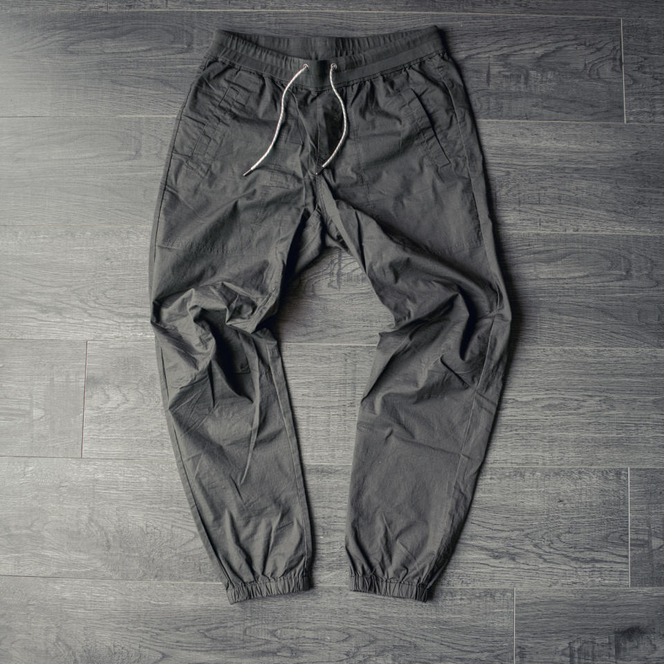 the vuori ripstop traveler joggers in dark oregano laying on my floor