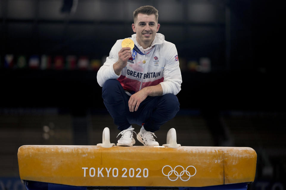 FILE - Max Whitlock of Britain poses for a picture after winning the gold medal for pommel horse during the artistic gymnastics men's apparatus final at the 2020 Summer Olympics, Sunday, Aug. 1, 2021, in Tokyo, Japan. Triple Olympic gold medalist Max Whitlock says he will end his 24-year gymnastics career after the Paris Olympics. (AP Photo/Natacha Pisarenko, File)