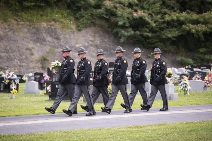 Kentucky state troopers walk out of the cemetery following the ceremony for Floyd County Deputy William Petry in Prestonsburg, Ky., Tuesday, July 5, 2022. Petry and two Prestonsburg city police officers were killed while serving a warrant at a home in the county. (Silas Walker/Lexington Herald-Leader via AP)