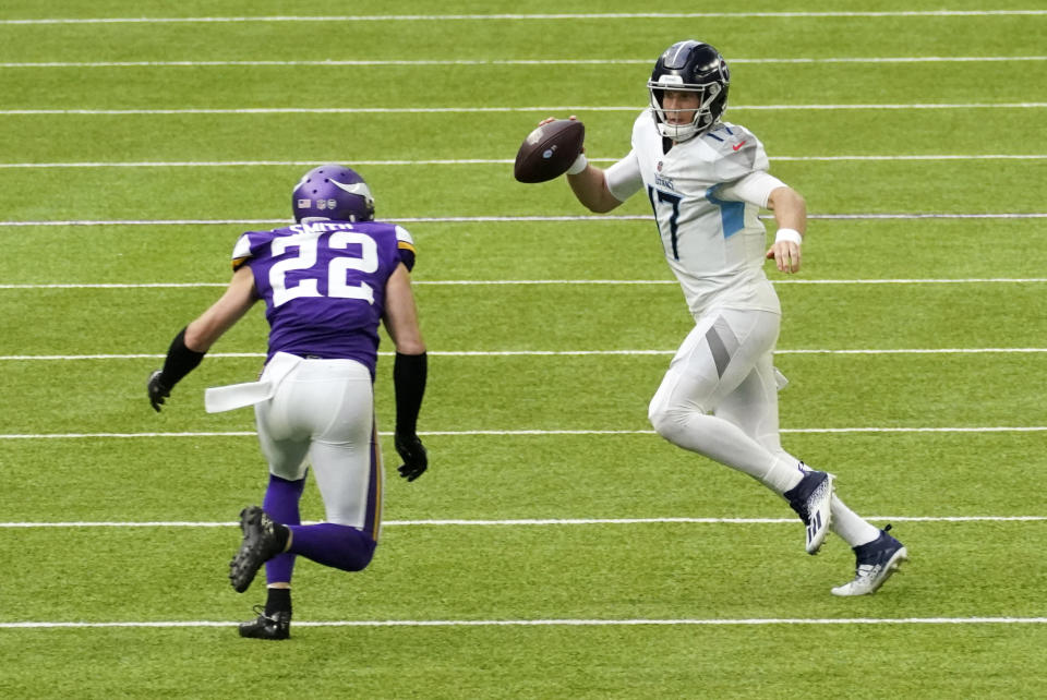 Tennessee Titans quarterback Ryan Tannehill (17) runs from Minnesota Vikings strong safety Harrison Smith (22) during the second half of an NFL football game, Sunday, Sept. 27, 2020, in Minneapolis. (AP Photo/Jim Mone)