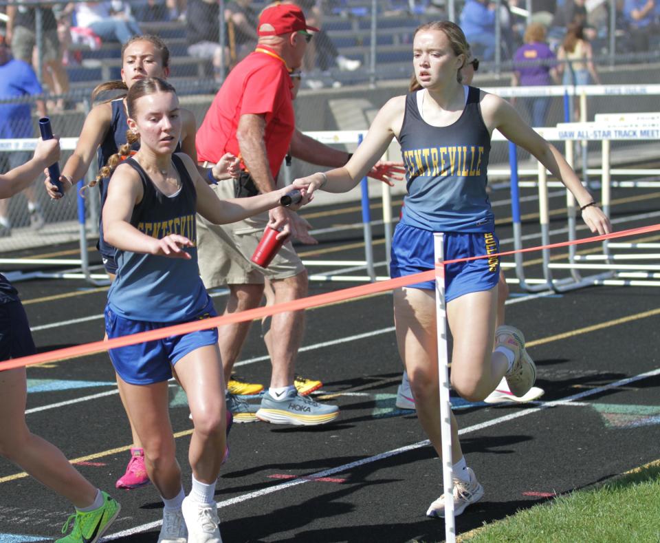 Ellie Reed hand the baton off to Arianna Six in the two-mile relay for Centreville on Saturday. They ran to third place.