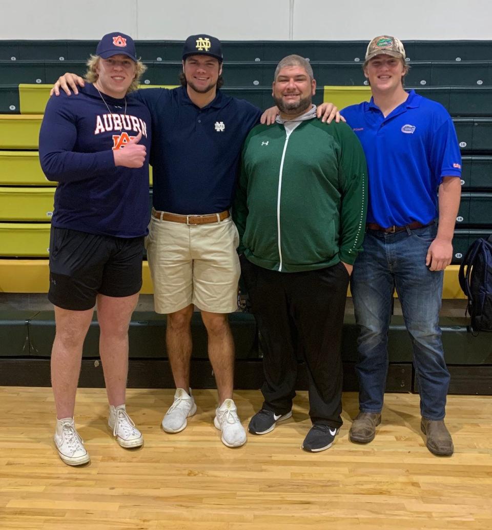 Brian Lane, then offensive line coach at Trinity Catholic, with linemen who signed with Power 5 programs that year: Garner Langlo (Auburn), Jake Slaughter (Florida) and Caleb Johnson (Notre Dame).