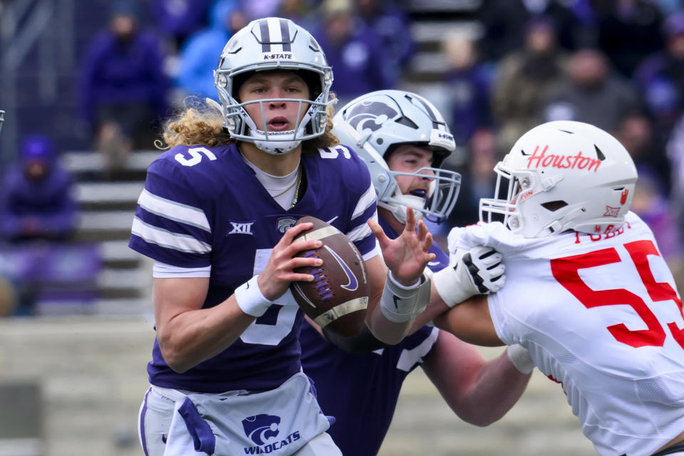 Kansas State quarterback Avery Johnson scrambles away from Houston pressure during the second half of an NCAA college football game in Manhattan, Kan., Saturday, Oct. 28, 2023. (AP Photo/Reed Hoffmann)