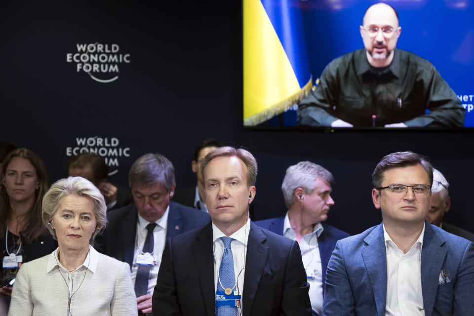 FILE - Ursula von der Leyen, President of the European Commission, Borge Brende, President, World Economic Forum and Dmytro Kuleba, Minister of Foreign Affairs of Ukraine listen to Denys Shmygal, Prime Minister of Ukraine, on screen, during a video meeting at the 51st annual meeting of the World Economic Forum, WEF, in Davos, Switzerland, Wednesday, May 25, 2022. As Russia’s invasion of Ukraine grinds into its fourth month, officials in Kyiv have expressed fears that the specter of “war fatigue” could erode the West’s resolve in helping the country push back Moscow’s aggression. (Laurent Gillieron/Keystone via AP, File)