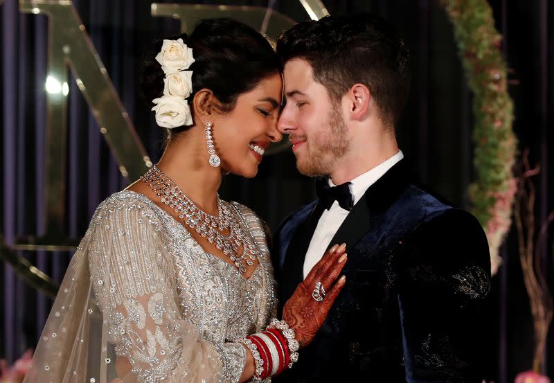 FILE PHOTO: Bollywood actress Priyanka Chopra and her husband singer Nick Jonas pose during a photo opportunity at their wedding reception in New Delhi