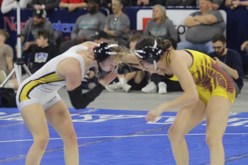 In the final high school bout for both girls, Cascade's Lily Grismer (in white singlet) squares off against defending 113-pound champion Jazmin Gorder of Poplar Saturday in the finals of the All-Class State Wrestling Tournament Saturday, Feb. 12, 2022 at Bllings' First Interstate Bank Arena.