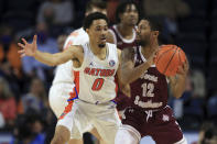 Florida guard Myreon Jones (0) defends against Texas Southern guard John Jones (12) during the first half of an NCAA college basketball game Monday, Dec. 6, 2021, in Gainesville, Fla. (AP Photo/Matt Stamey)