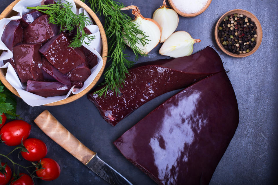 Raw beef liver over gray background viewed from above