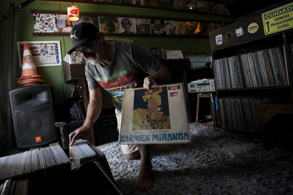 Deejay Mustafa Baba-Aissa, originally from Algeria, shows a copy of Carmen Miranda's The Brazilian Bombshell Ace of Hearts 1965 album, in his Vinil do Mustafa record shop, in Rio de Janeiro, Brazil, Friday, April 19, 2024. In Brazil, surging interest in vinyl records are listeners interested in classic albums and discovering new artists or once-obscure musicians. (AP Photo/Bruna Prado)