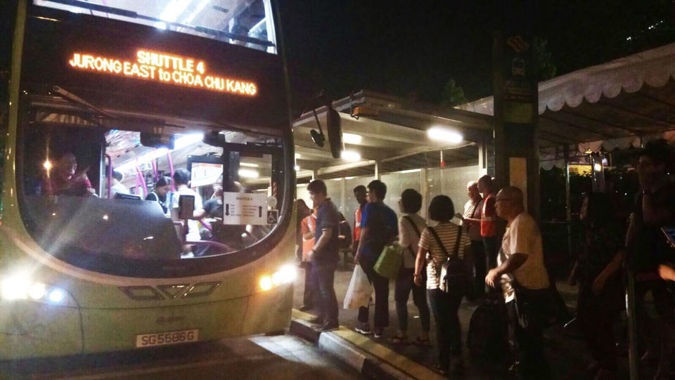 The first bus for shuttle bus service 4 heading towards Choa Chu Kang arrived at Jurong East Station at around 11.15pm. Around 40-50 commuters were spotted in line for the service. PHOTO: Wong Casandra/Yahoo News Singapore
