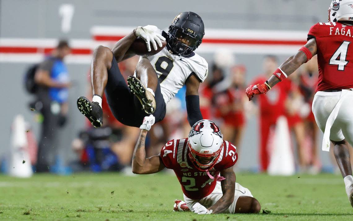 N.C. State cornerback Derrek Pitts Jr. (24) tackles Wake Forest wide receiver A.T. Perry (9) during the first half of N.C. State’s game against Wake Forest at Carter-Finley Stadium in Raleigh, N.C., Saturday, Nov. 5, 2022.