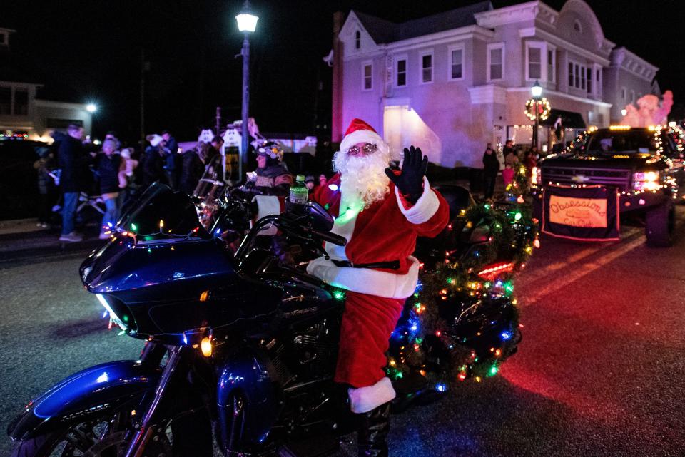 The Ramsey Home for the Holidays Parade heads along East Main Street on Friday December 4, 2021. Santa waves from his motorcycle.