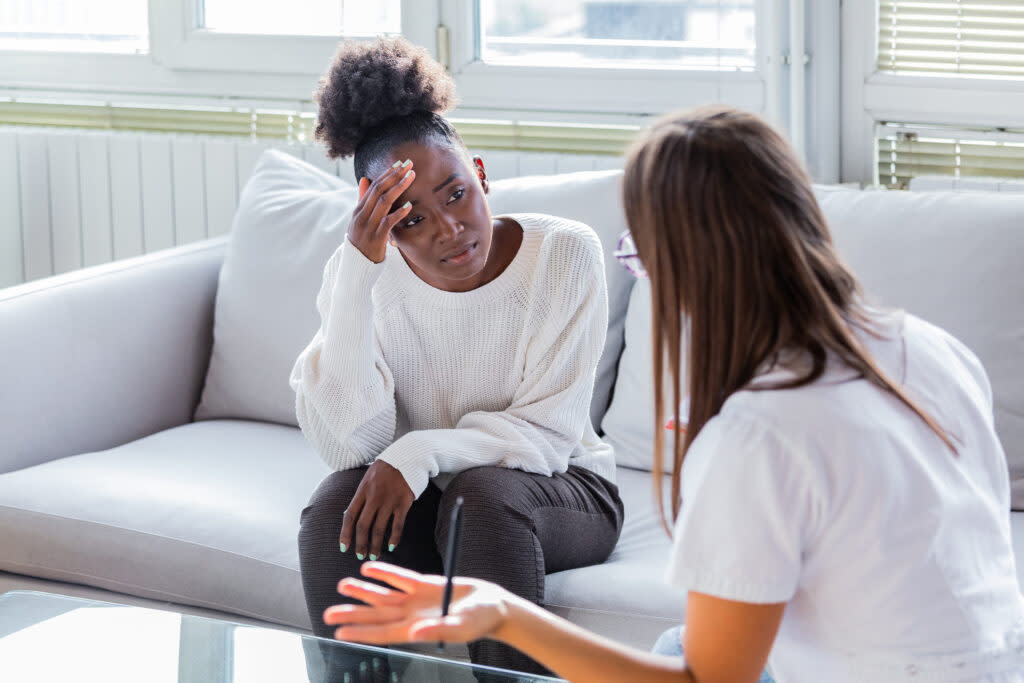 a patient is pictured receiving bad news from a health care provider