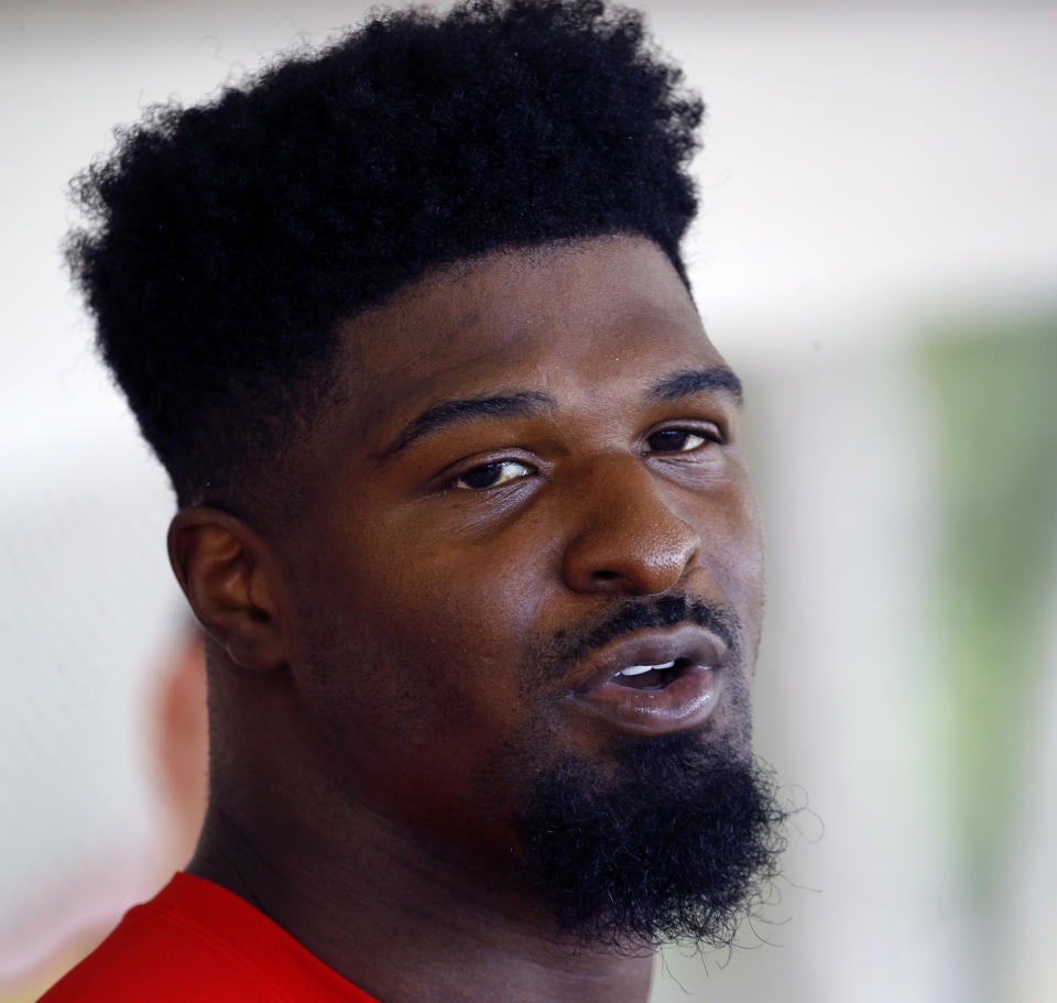 FILE - In this July 23, 2018, file photo, Kansas City Chiefs linebacker Dee Ford talks to the media at NFL football training camp in St. Joseph, Mo. A 47-year-old Englishwoman has seen the best and worst that Twitter would have to offer the American football player who shares her name. Dee Ford, of Kent, England, told the Kansas City Star that her "phone was going off literally nonstop" due to angry tweets from Kansas City Chiefs fans who thought they were venting at linebacker Dee Ford following his critical late penalty in last weekend's AFC Championship loss to the New England Patriots. (AP Photo/Charlie Riedel, File)