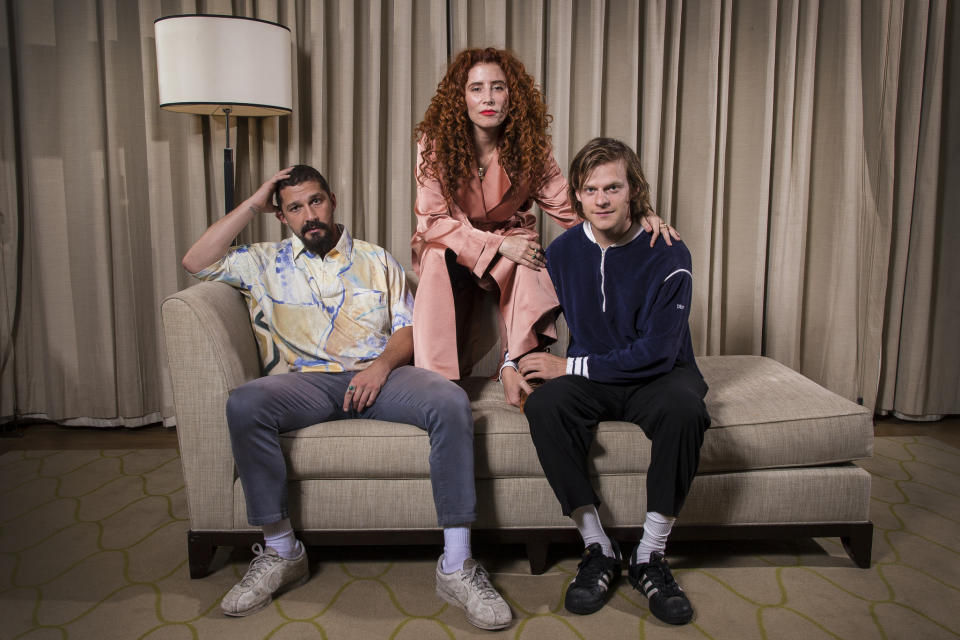 This Oct. 5, 2019 photo shows actor Shia LaBeouf, from left, director Alma Har'el and actor Lucas Hedges posing for a portrait to promote their film "Honey Boy" during the London Film Festival. (Photo by Joel C Ryan/Invision/AP)