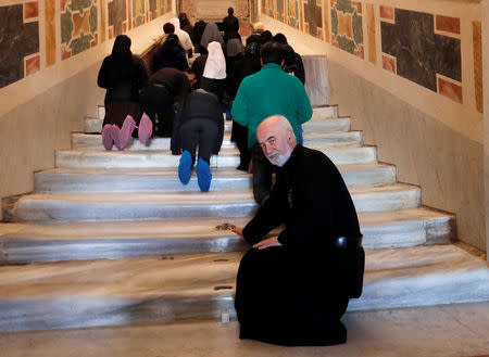 Rector of the Holy Stairs Sanctuary, Father Francesco Guerra, is pictured next to the Holy Stairs in Rome, Italy April 16 2019. REUTERS/Remo Casilli