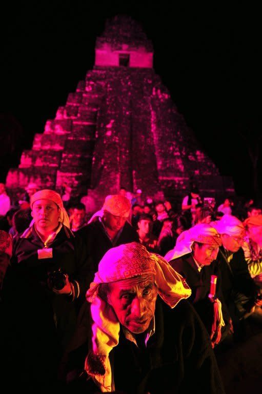 Guatemalan Mayan natives take part in celebrations marking the end of the Mayan era at the Tikal archaeological site, 560 kms north of Guatemala City, on December 21, 2012. A global day of lighthearted doom-themed celebration and superstitious scare-mongering culminated Friday in the jungle temples built by the Mayan people of Central America, whose calendar sparks fears of apocalypse