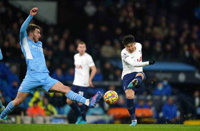 Son Heung-min, right, shoots at goal against Manchester City last season