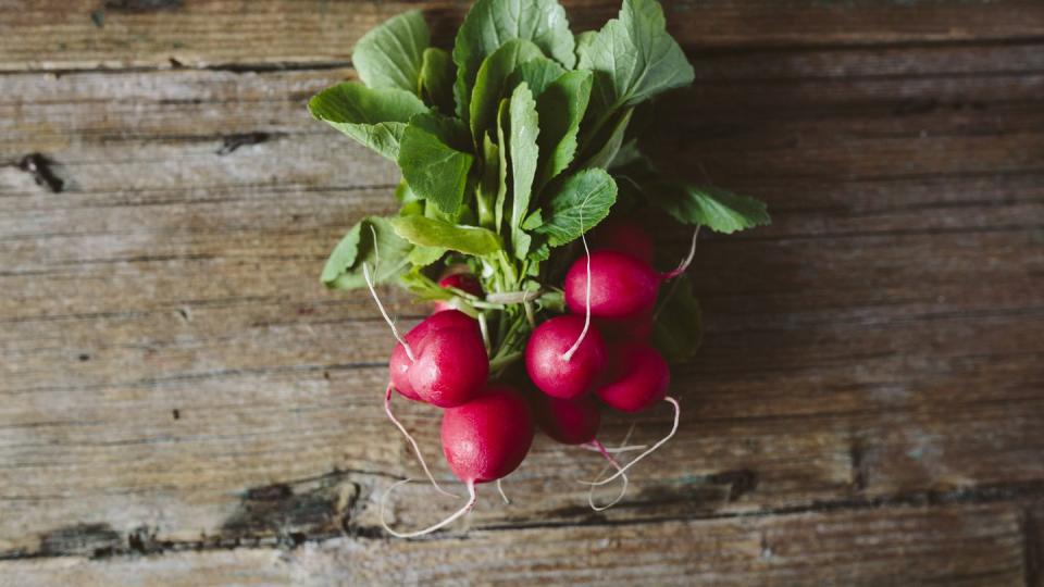 Bunch of red radishes on wood