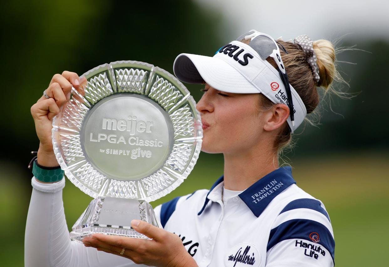 Nelly Korda kisses the trophy after winning the Meijer LPA Classic golf tournament, Sunday, June 20, 2021, in Grand Rapids, Mich. (AP Photo/Al Goldis)