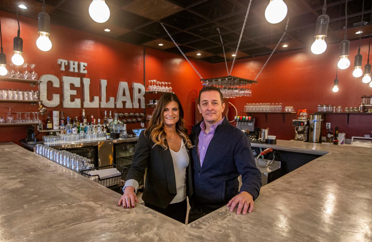 Owners Shawn and Lisa Todd stand inside Cellar Wine Bar and Kitchen on Wednesday, Jan. 19, 2022, in South Bend. 