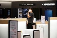 A customer wearing a mask to avoid the spread of the coronavirus disease (COVID-19) shops at a Samsung Electronics' store in Seoul