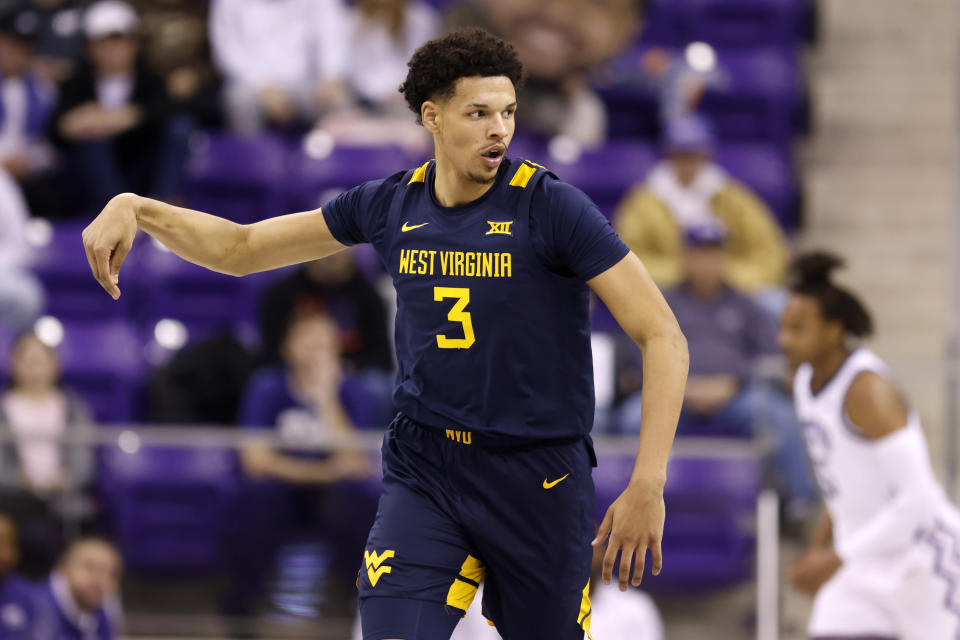 West Virginia forward Tre Mitchell celebrates after sinking a three-point shot in the first half of an NCAA college basketball game against TCU, Tuesday, Jan. 31, 2023, in Fort Worth, Texas. (AP Photo/Ron Jenkins)