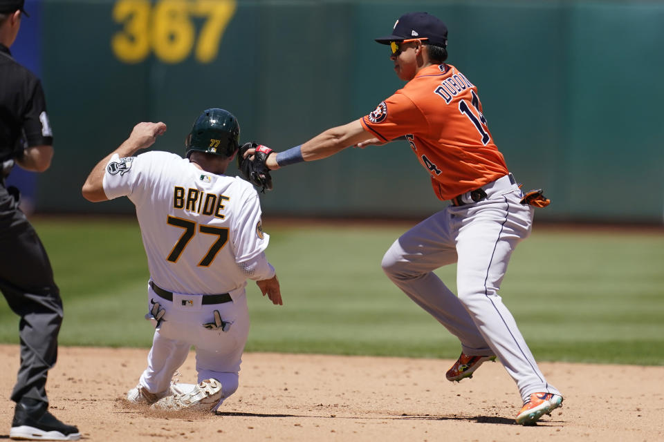 Oakland Athletics' Jonah Bride (77) steals second base next to Houston Astros shortstop Mauricio Dubon during the fifth inning of a baseball game in Oakland, Calif., Wednesday, July 27, 2022. (AP Photo/Jeff Chiu)
