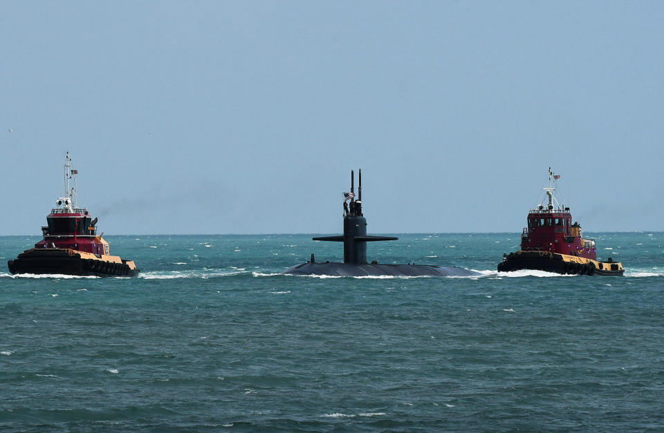 A nuclear submarine above water.