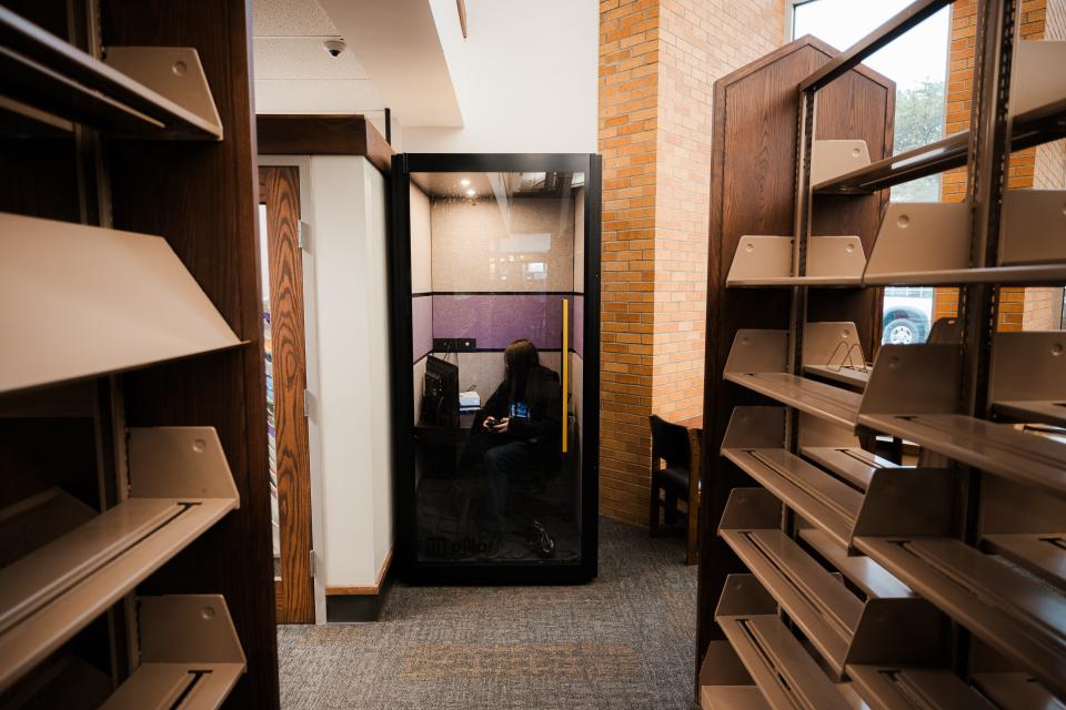 A patron uses one of two "hush rooms" recently added to the Bartlesville Public Library.
