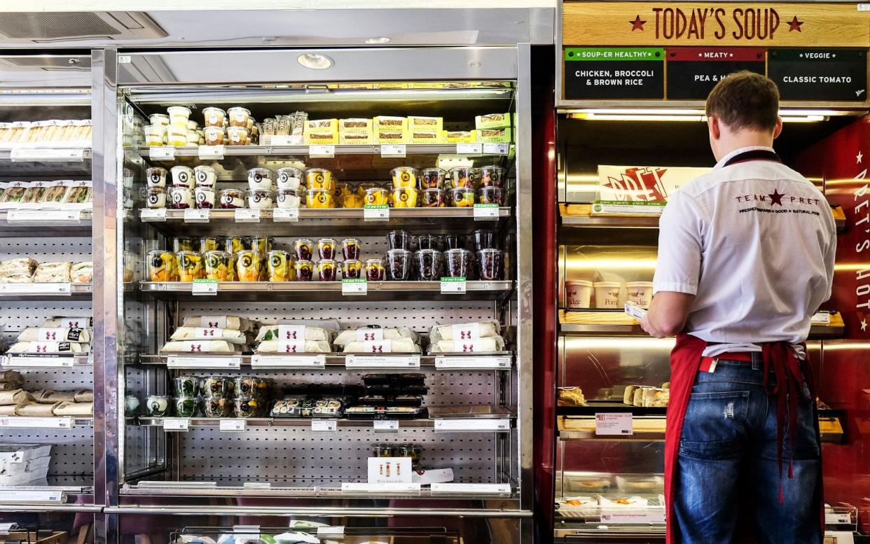 A Pret a Manger employee stocks shelves. Its yogurt bowls have been criticised for their high sugar content by a Harley Street nutritionist