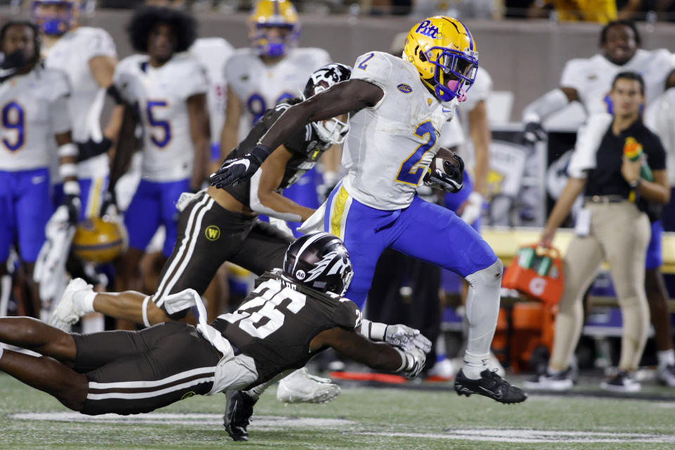 Pittsburgh running back Israel Abanikanda, right, rushes against Western Michigan's Delano Ware (26) during the second half of an NCAA college football game Saturday, Sept. 17, 2022, in Kalamazoo, Mich. Pittsburgh won 34-13. (AP Photo/Al Goldis)