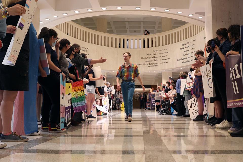 Maxx Fenning, 19, walks among a group of people protesting House Bill 1557, also known as the &quot;Don't Say Gay&quot; bill by critics, on the fourth floor of the Florida Capitol in March 2022.