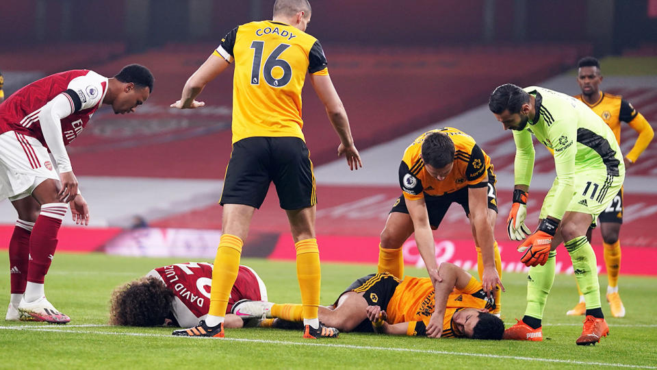 Both Wolves and Arsenal players were concerned after a clash of heads between David Luiz and Raul Jimenez left the later unconscious on the ground. (Photo by JOHN WALTON/POOL/AFP via Getty Images)