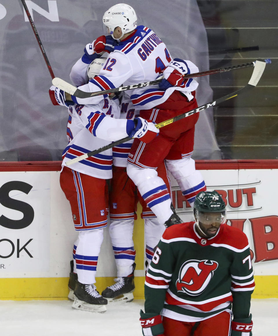 New Jersey Devils defenseman P.K. Subban (76) skates back to the bench as the New York Rangers celebrate a goal by center Kevin Rooney (obscured) during the first period of an NHL hockey game in Newark N.J., on Saturday, March 6, 2021. (Andrew Mills/NJ Advance Media via AP)
